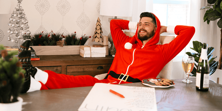 About Us Page - Image of man wearing a santa jumpsuit